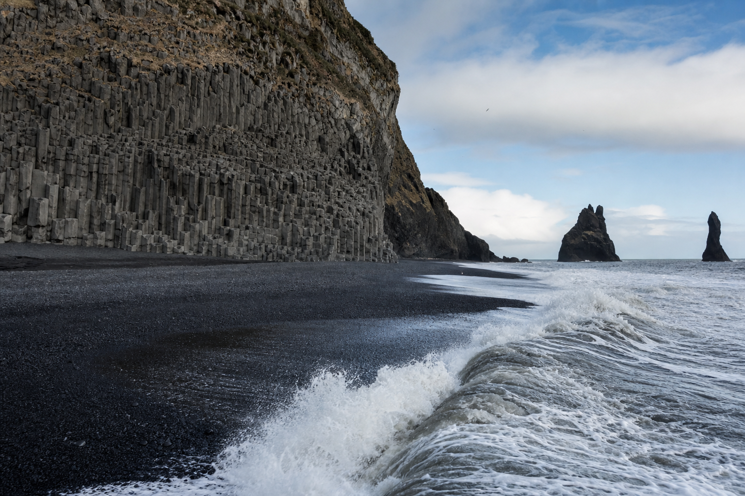 초록빛 가파른 언덕 아래에 관람객이 모여 있고 참가자들이 치즈를 따라 내려오는 장면